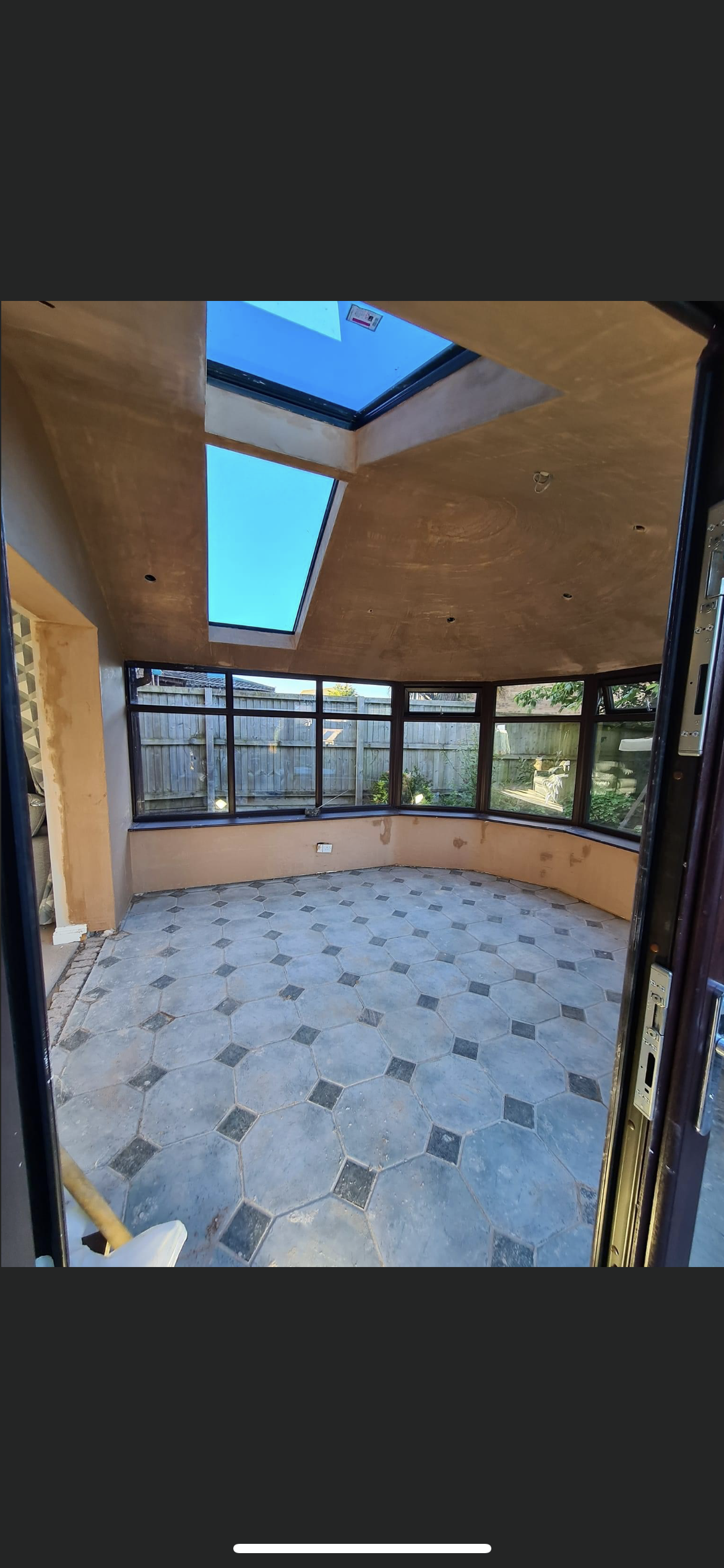 A room with a lot of windows and a skylight in the ceiling.