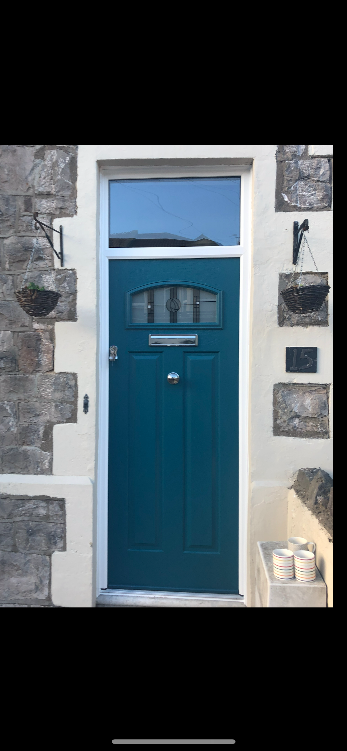 A blue door is on the side of a building.