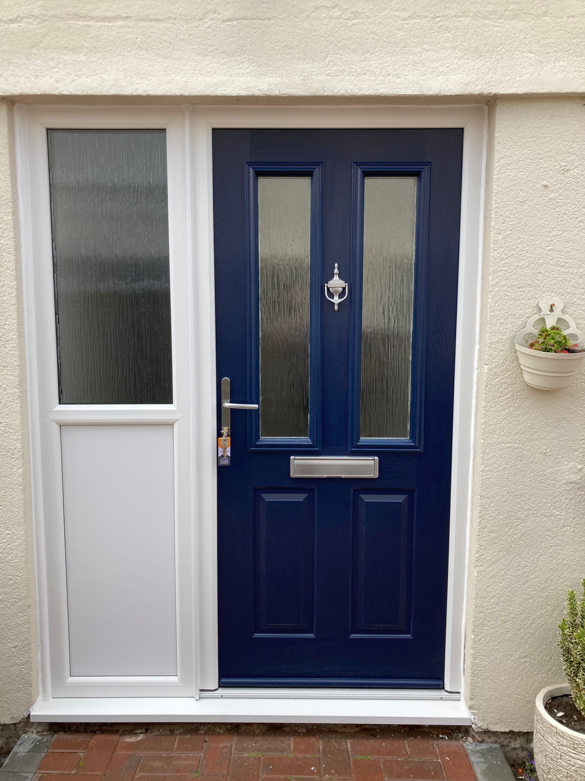 A blue door with a white trim is on a white wall.
