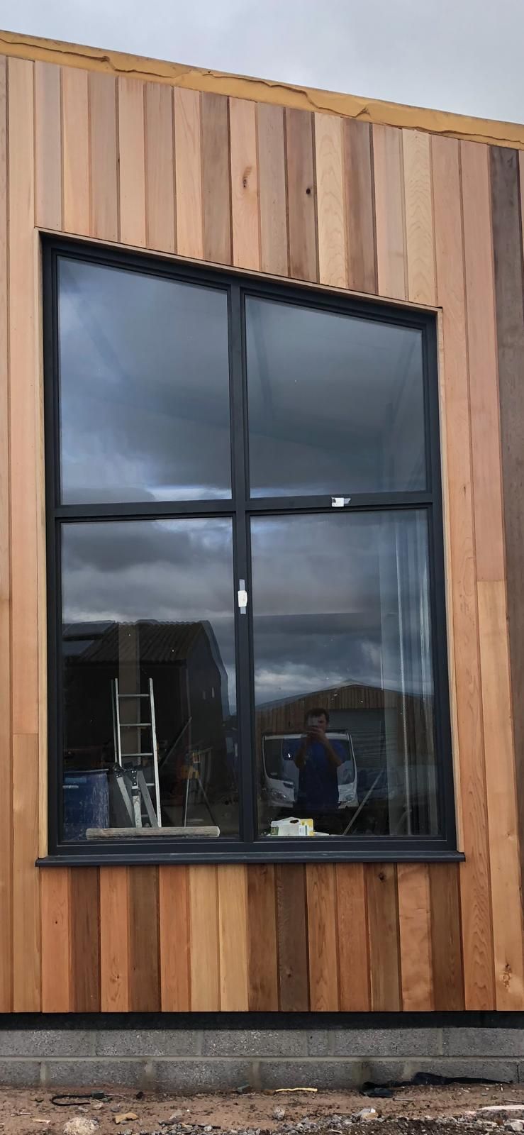 A large window on the side of a wooden building.
