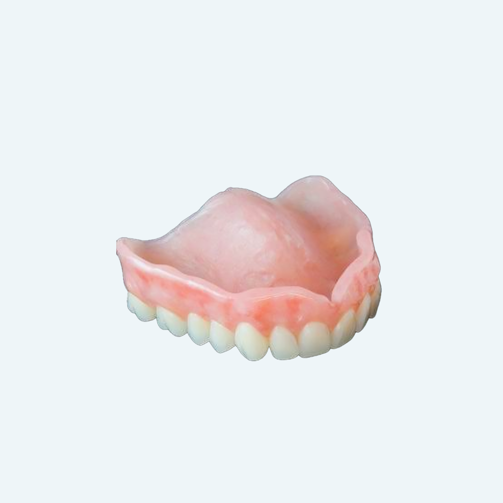 Partial dental prosthesis with pink gum-colored base and white teeth.