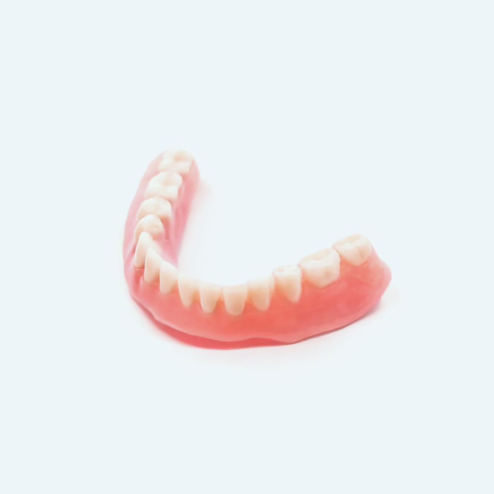 Upper dental denture, pink gum-colored base with white teeth, on a white background.
