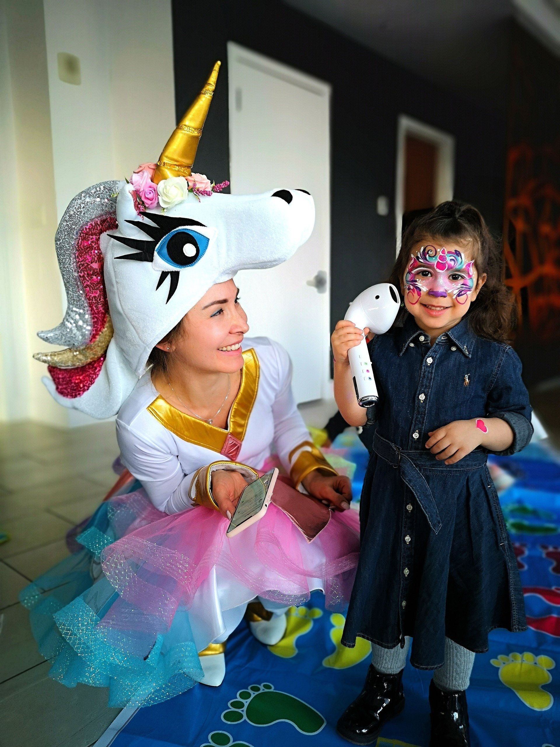 Unicorn birthday party. Face painting and games by unicorn character