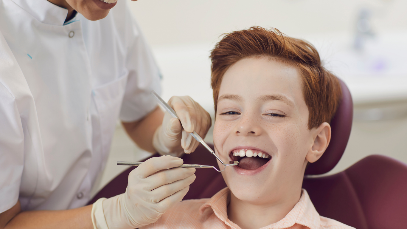 Dentist examining a smiling patient in a dental chair with tools and gloved hands