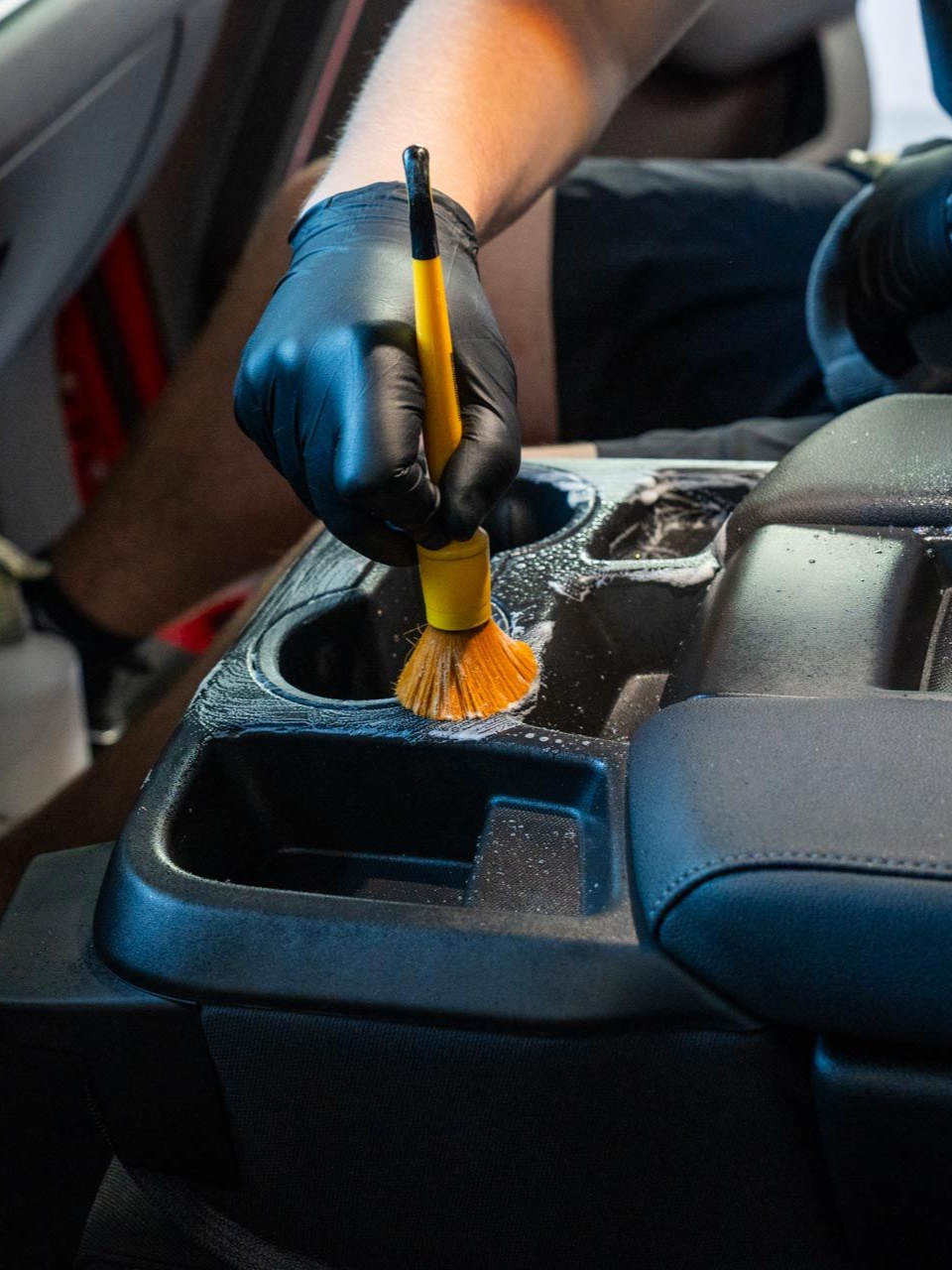 A close up of a car being washed in a garage