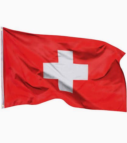 Swiss flag on a red field, white cross centered, waving in the wind