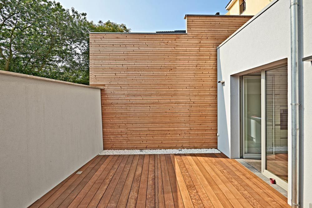 A Wooden Deck in Front of a White Building — Timbertop Floor Sanding & Polishing In Normanton, QLD