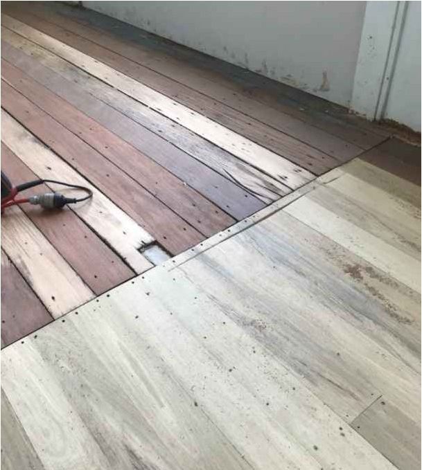 A Close Up of a Wooden Floor With a Drill on It — Timbertop Floor Sanding & Polishing In Bungalow, QLD