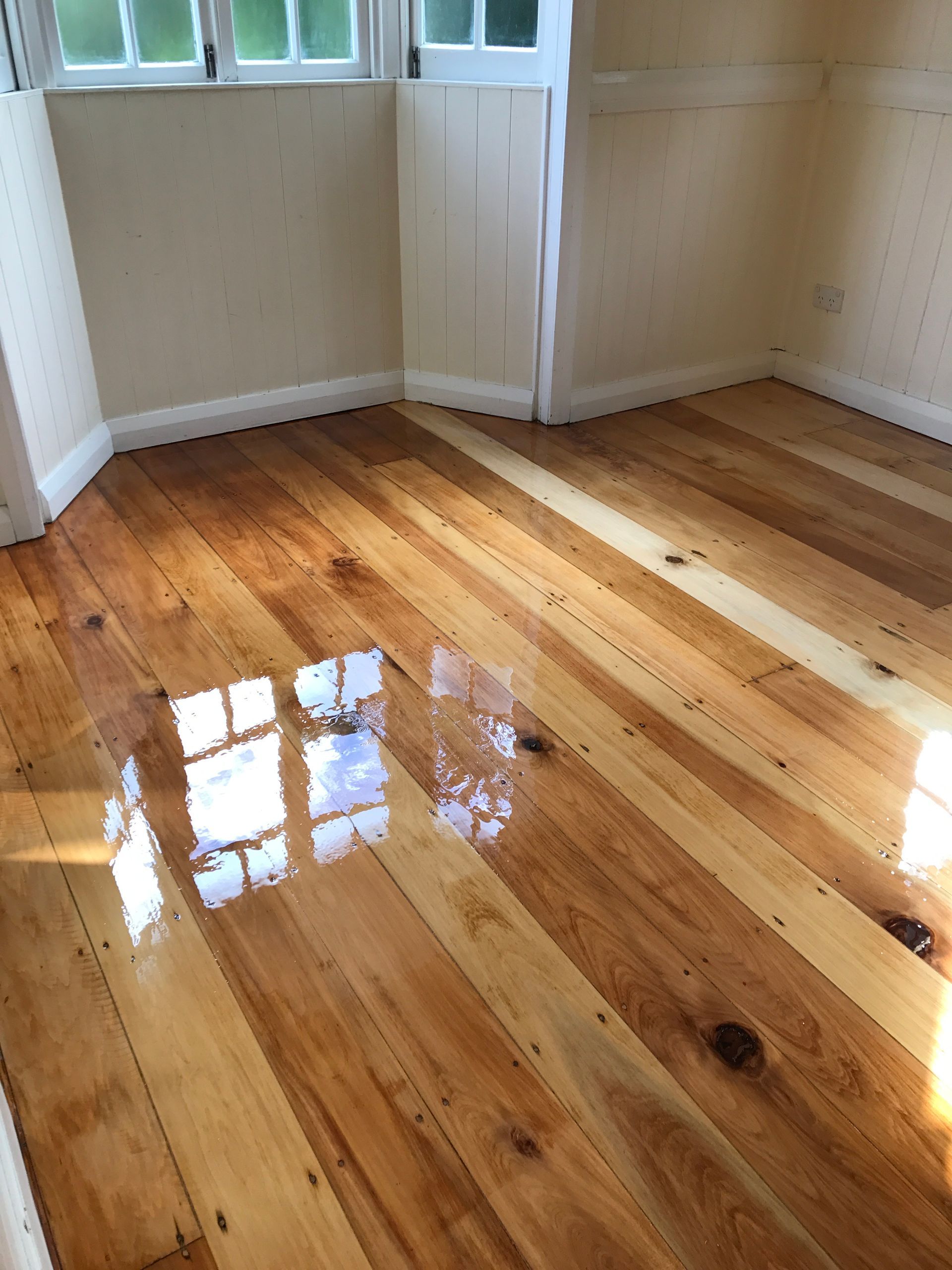 A Room With a Wooden Floor and a Window — Timbertop Floor Sanding & Polishing In Bungalow, QLD