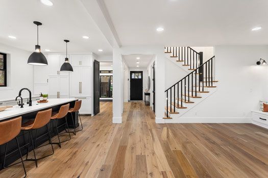 A Kitchen With a Wooden Floor and Stairs in a House — Timbertop Floor Sanding & Polishing In Cairns, QLD
