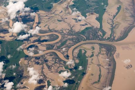 An Aerial View of a River Surrounded by Trees and Clouds — Timbertop Floor Sanding & Polishing In Normanton, QLD