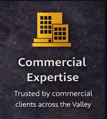 A golden icon of commercial buildings above the text: