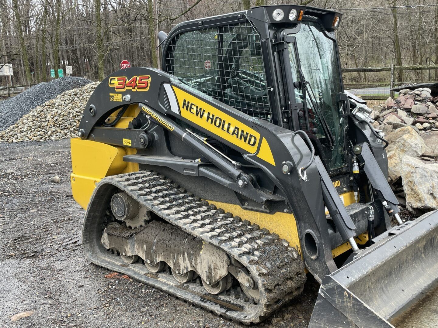 work equipment picking up piles of stone