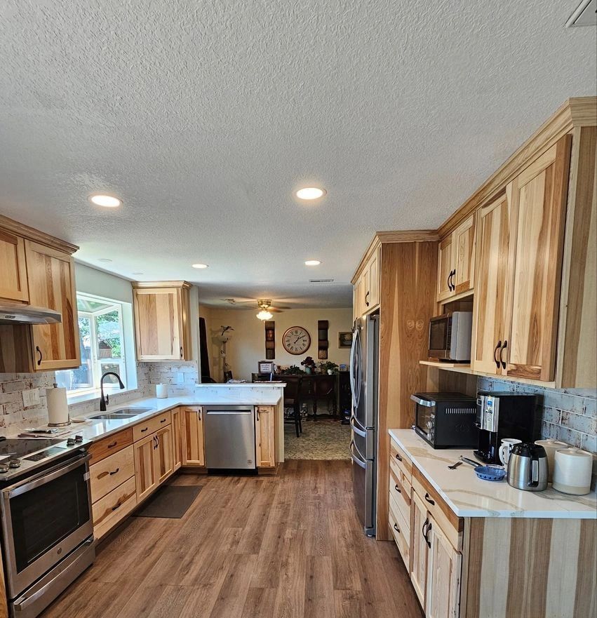 A kitchen with wooden cabinets and stainless steel appliances