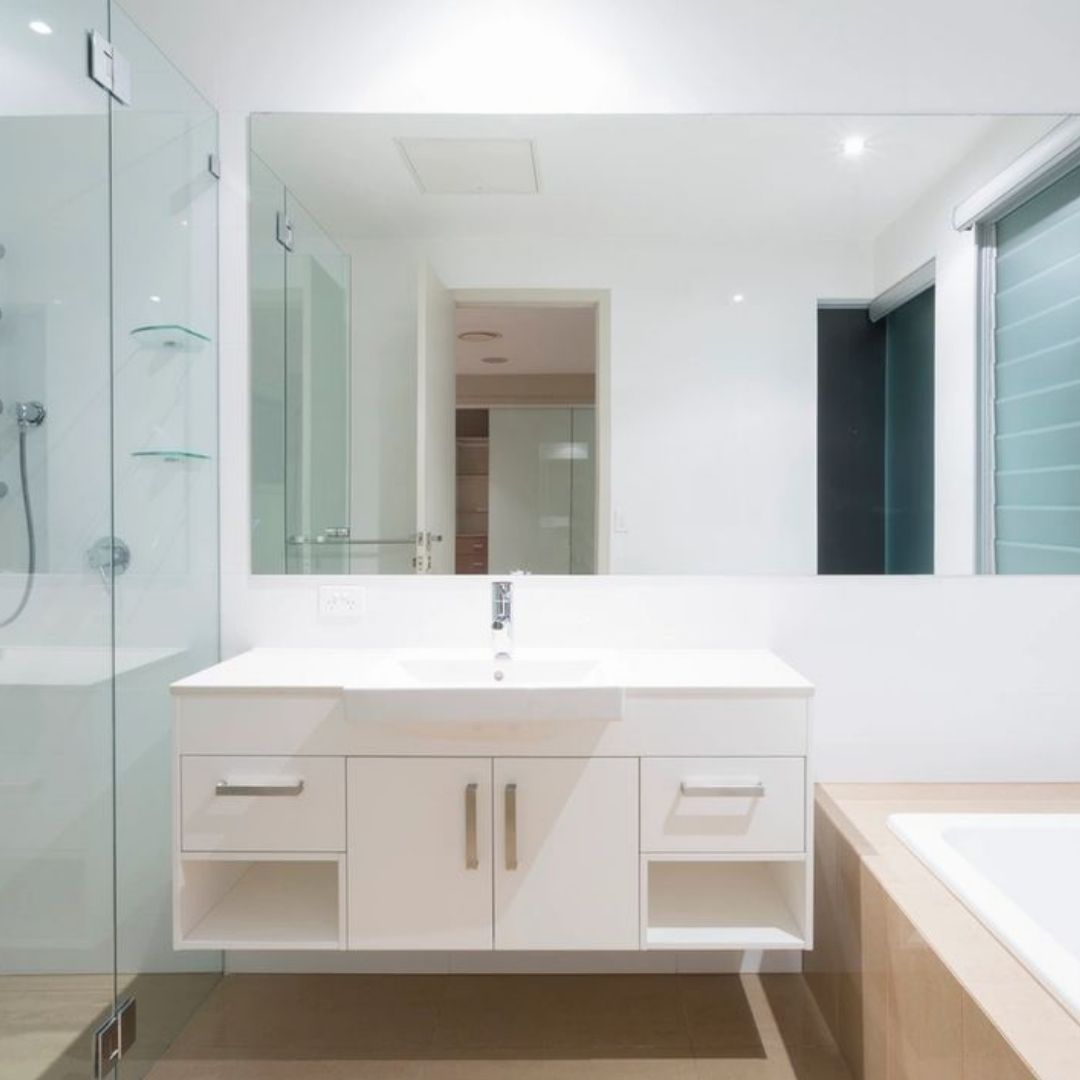 A bathroom with a sink and a large mirror