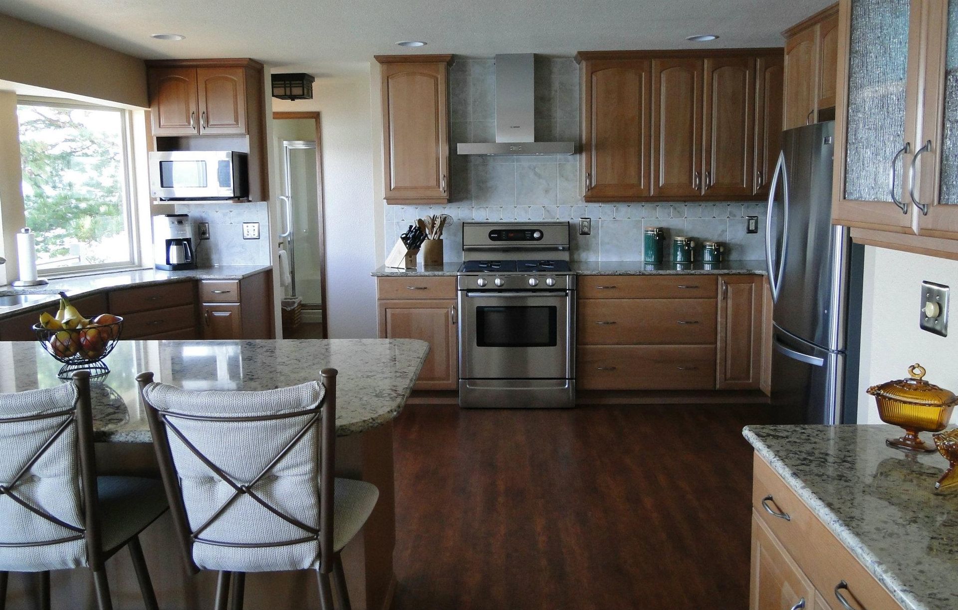 A kitchen with stainless steel appliances and wooden cabinets