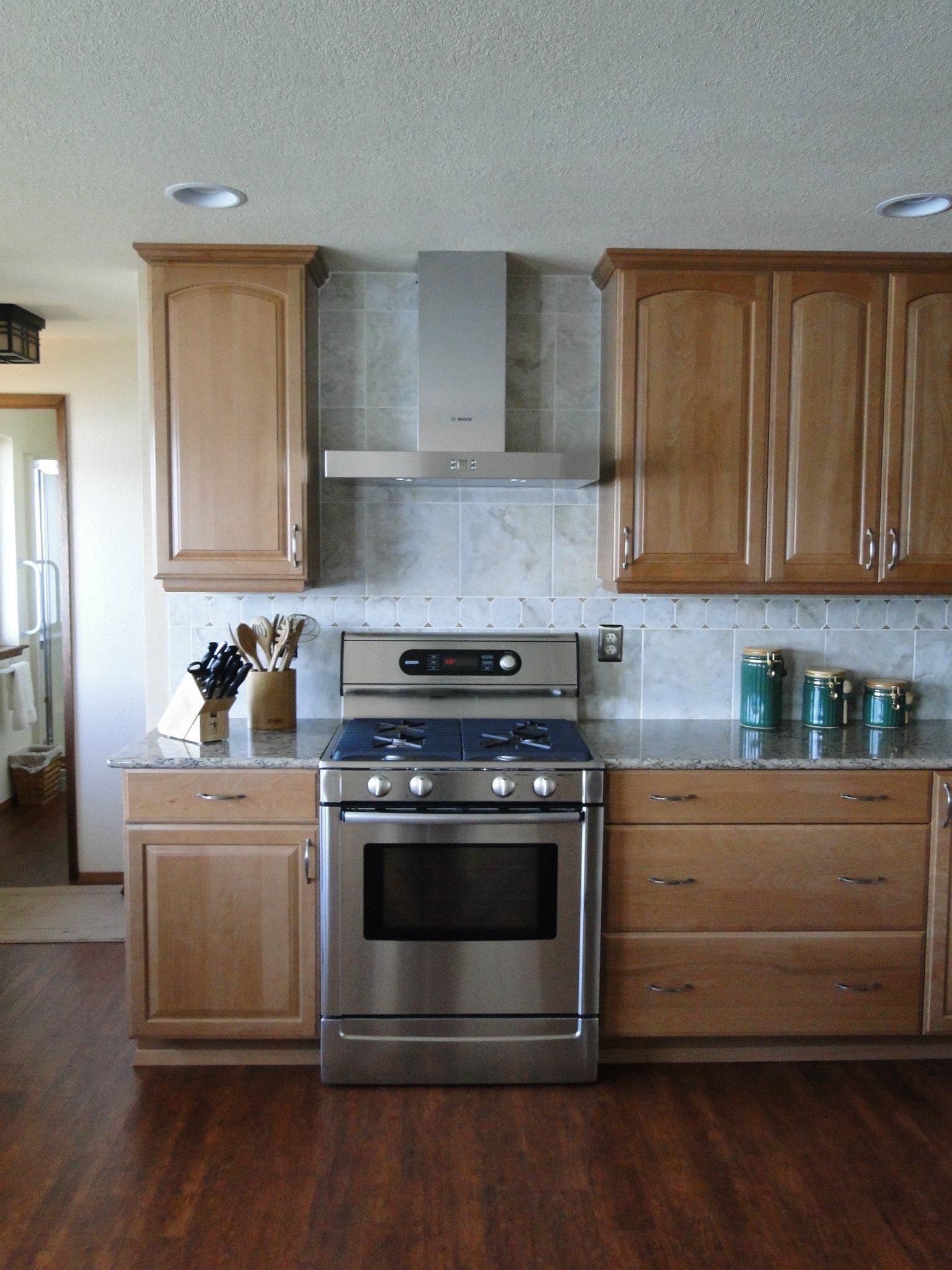 A kitchen with stainless steel appliances and wooden cabinets