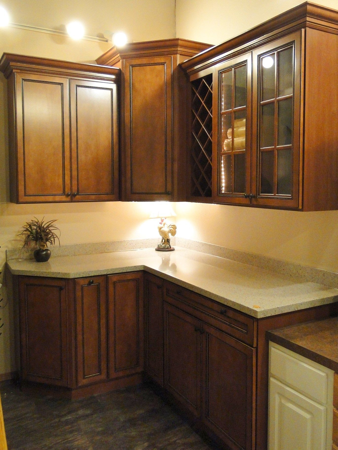 A kitchen with wooden cabinets and granite counter tops