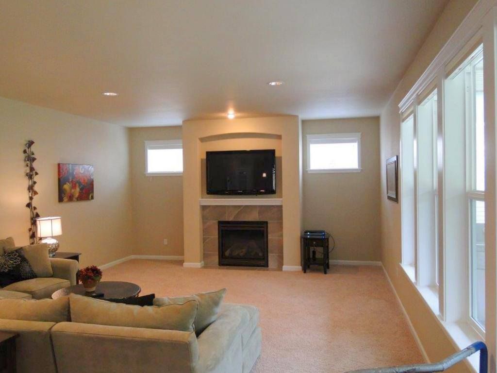 A living room with a fireplace and a flat screen tv