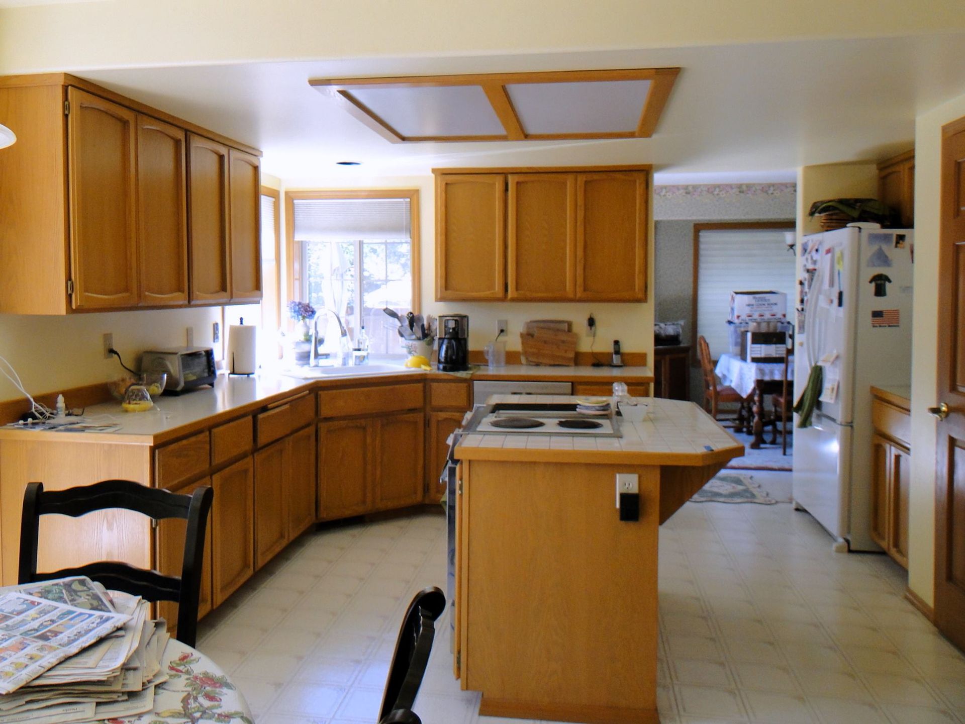 A kitchen with wooden cabinets and a white refrigerator