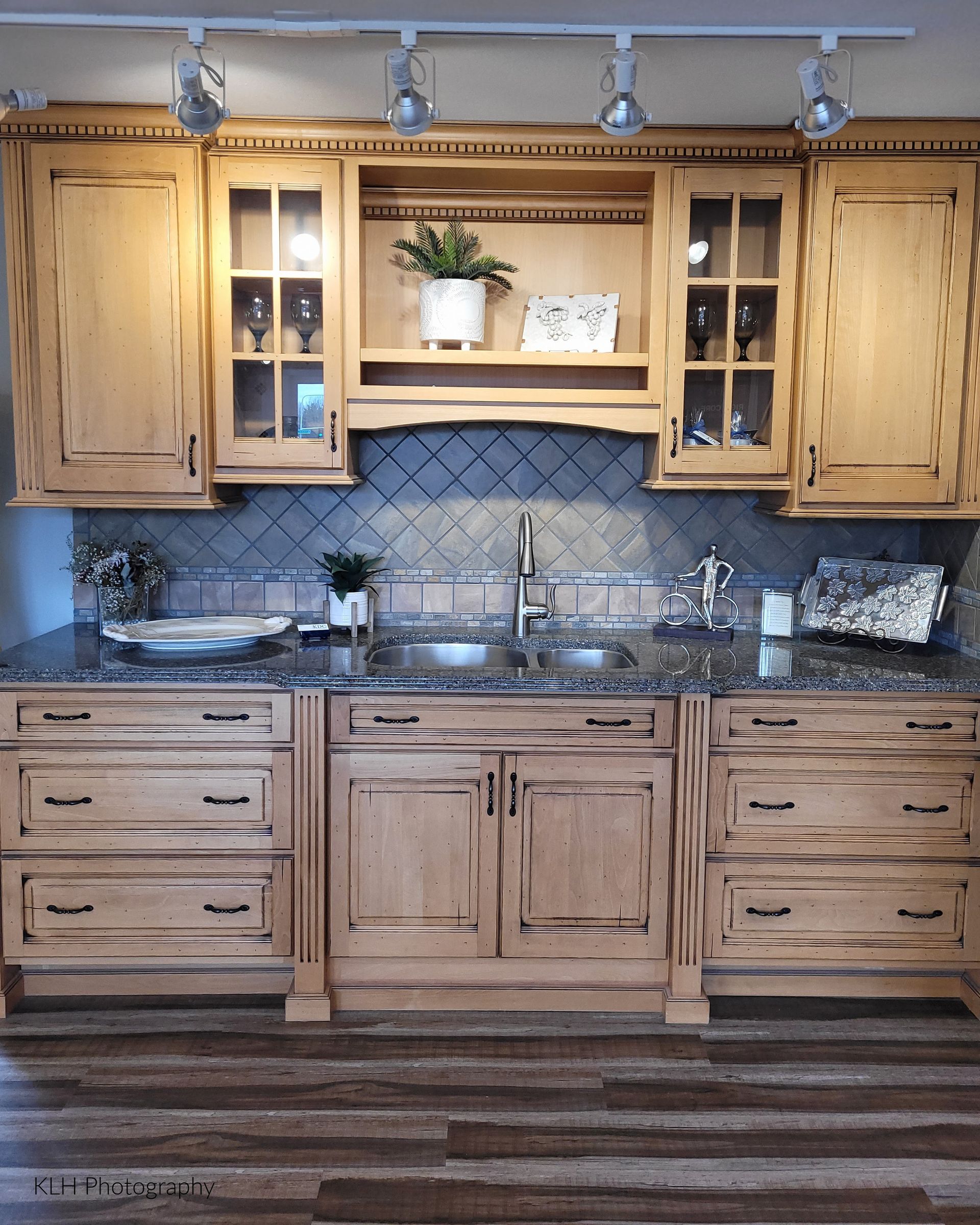 A kitchen with wooden cabinets and granite counter tops