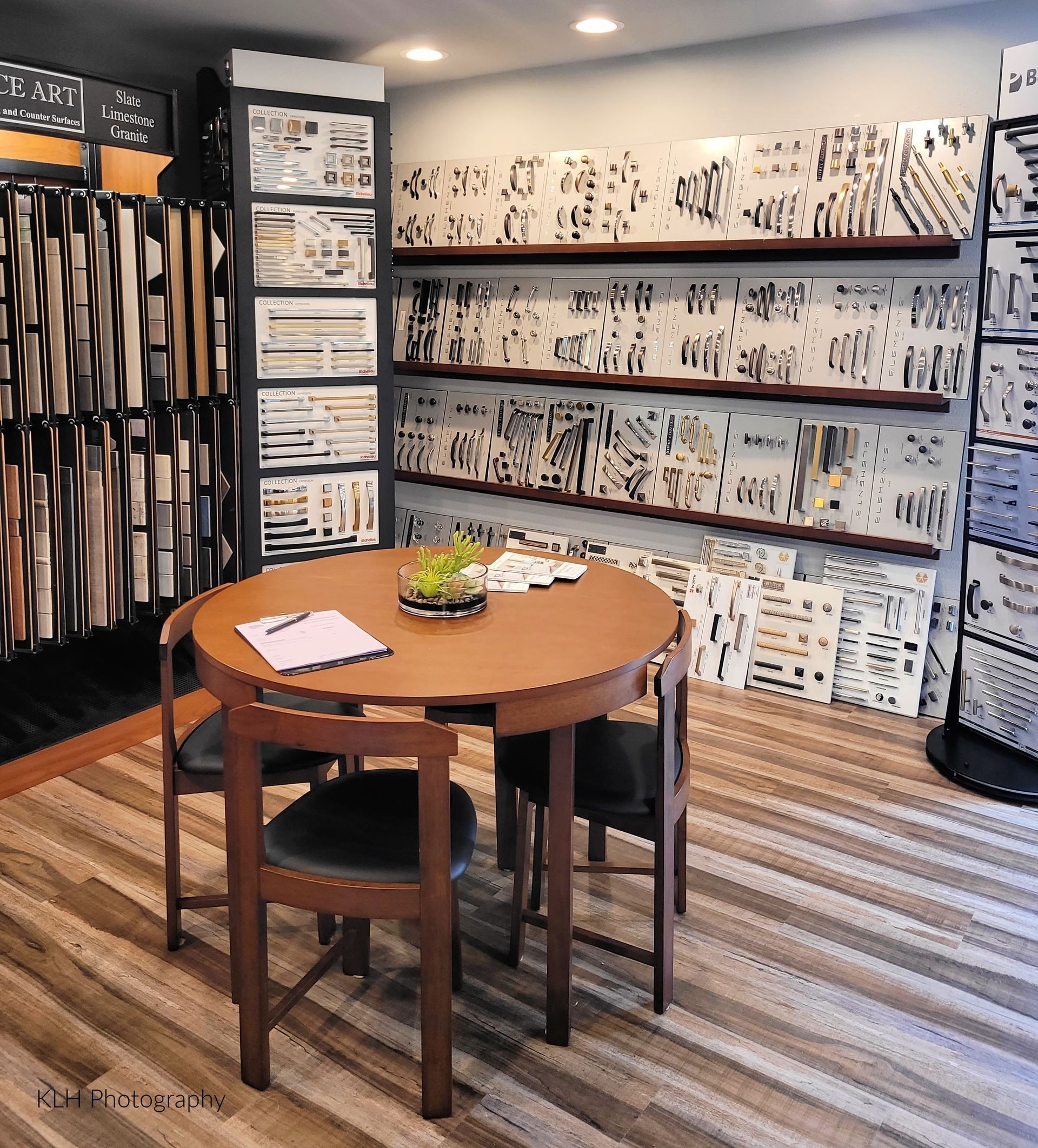 A room with a round table and chairs in it