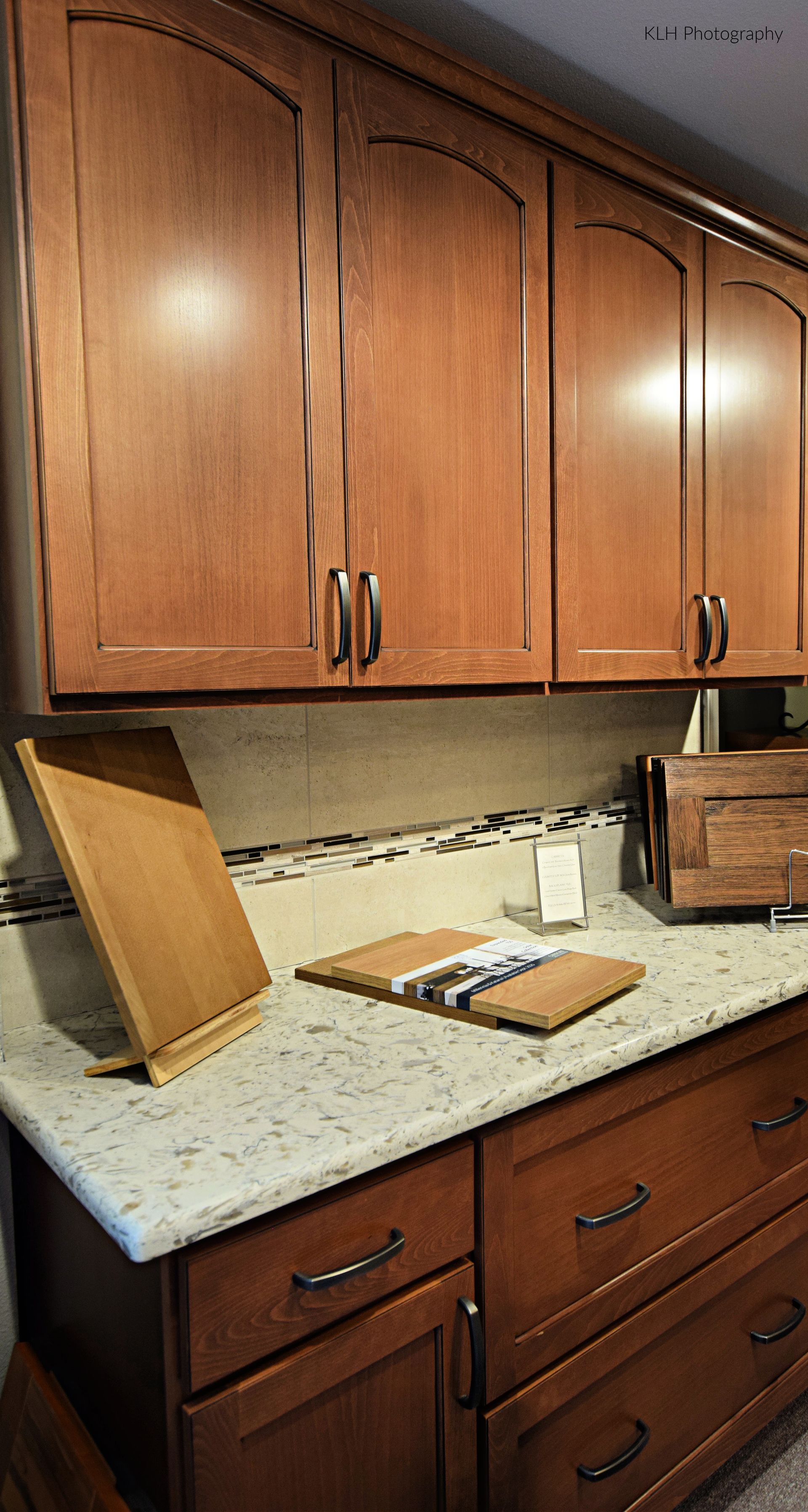 A kitchen with wooden cabinets and a granite counter top.