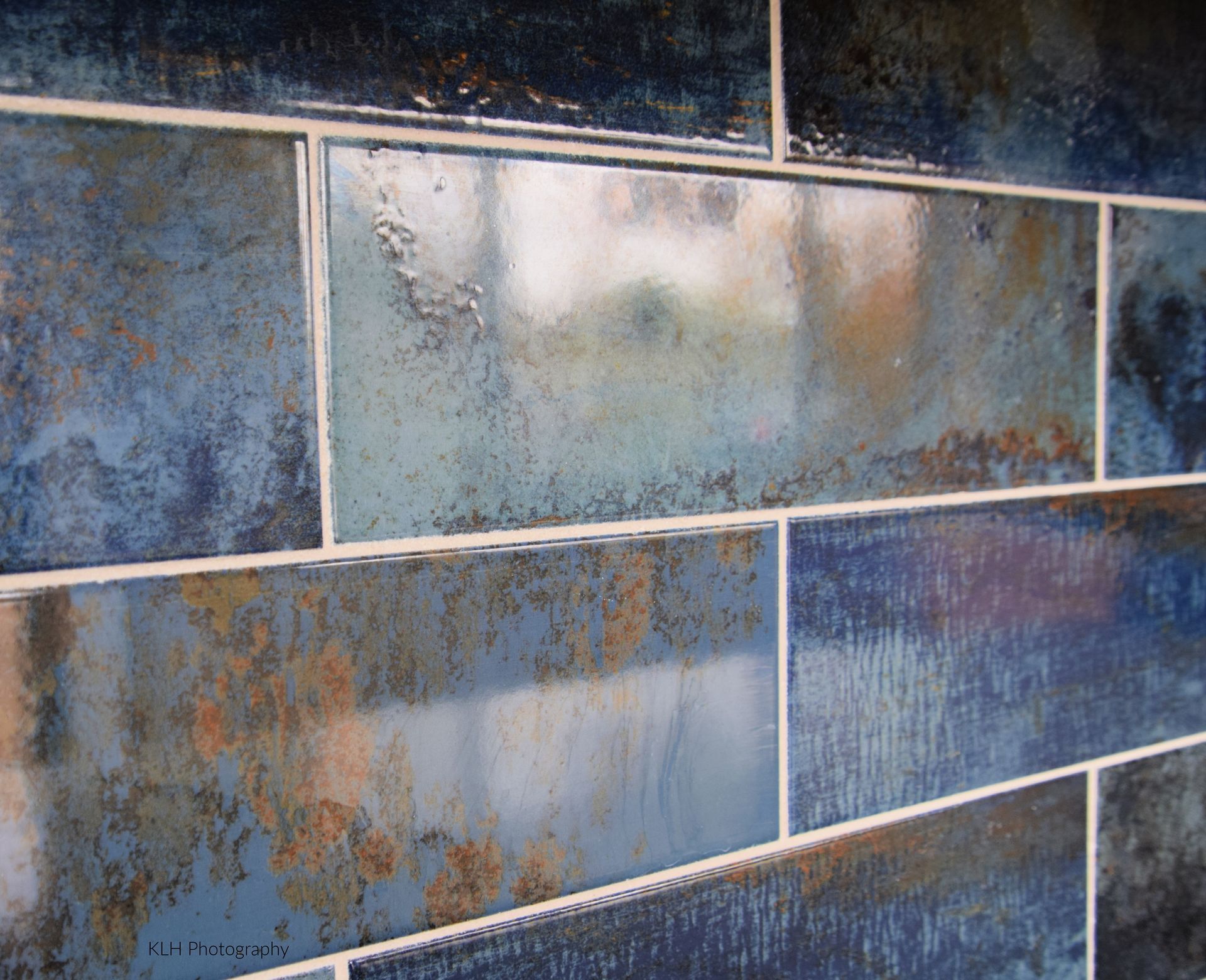 A close up of a blue tile wall