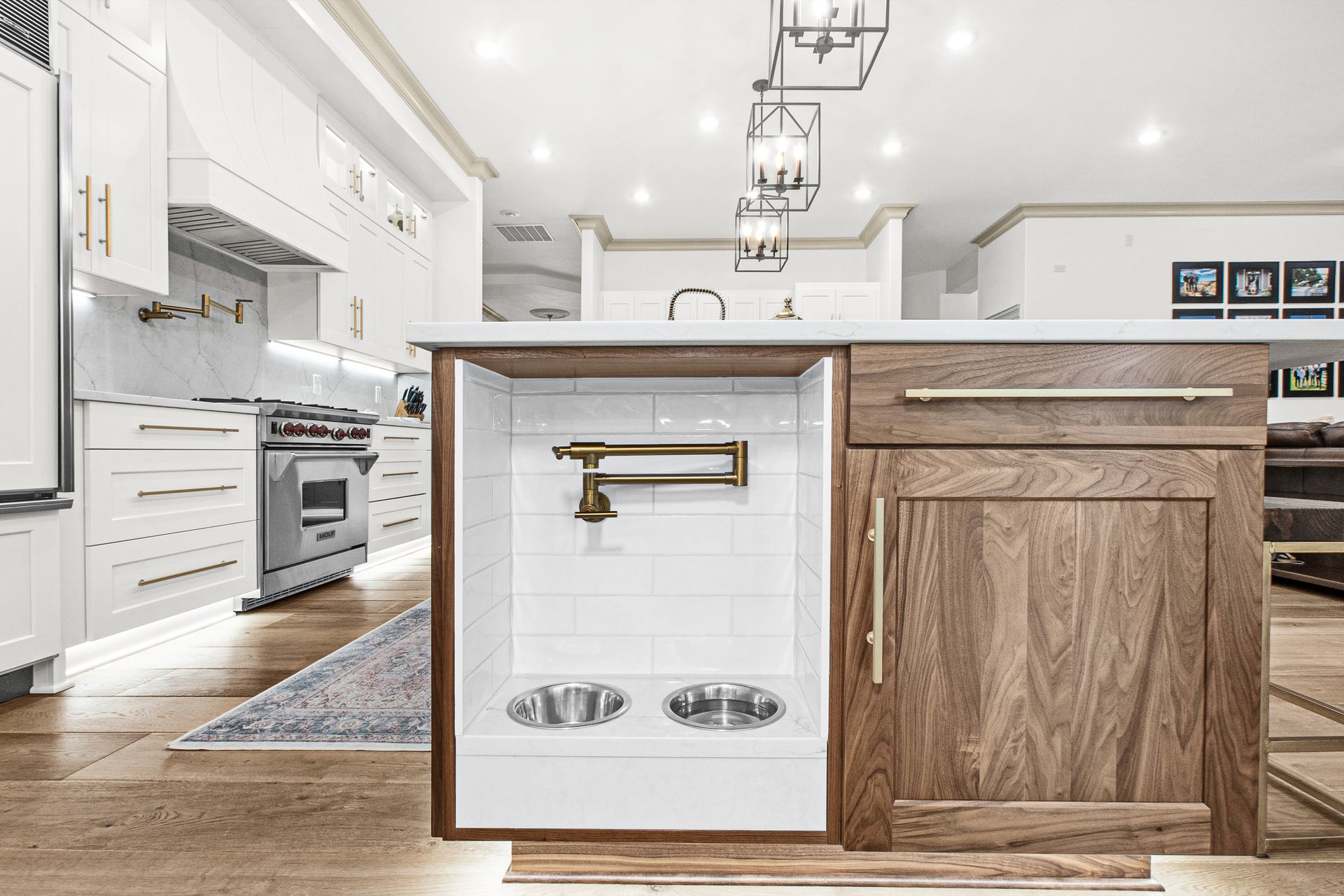 A kitchen with a dog bowl holder under the sink.