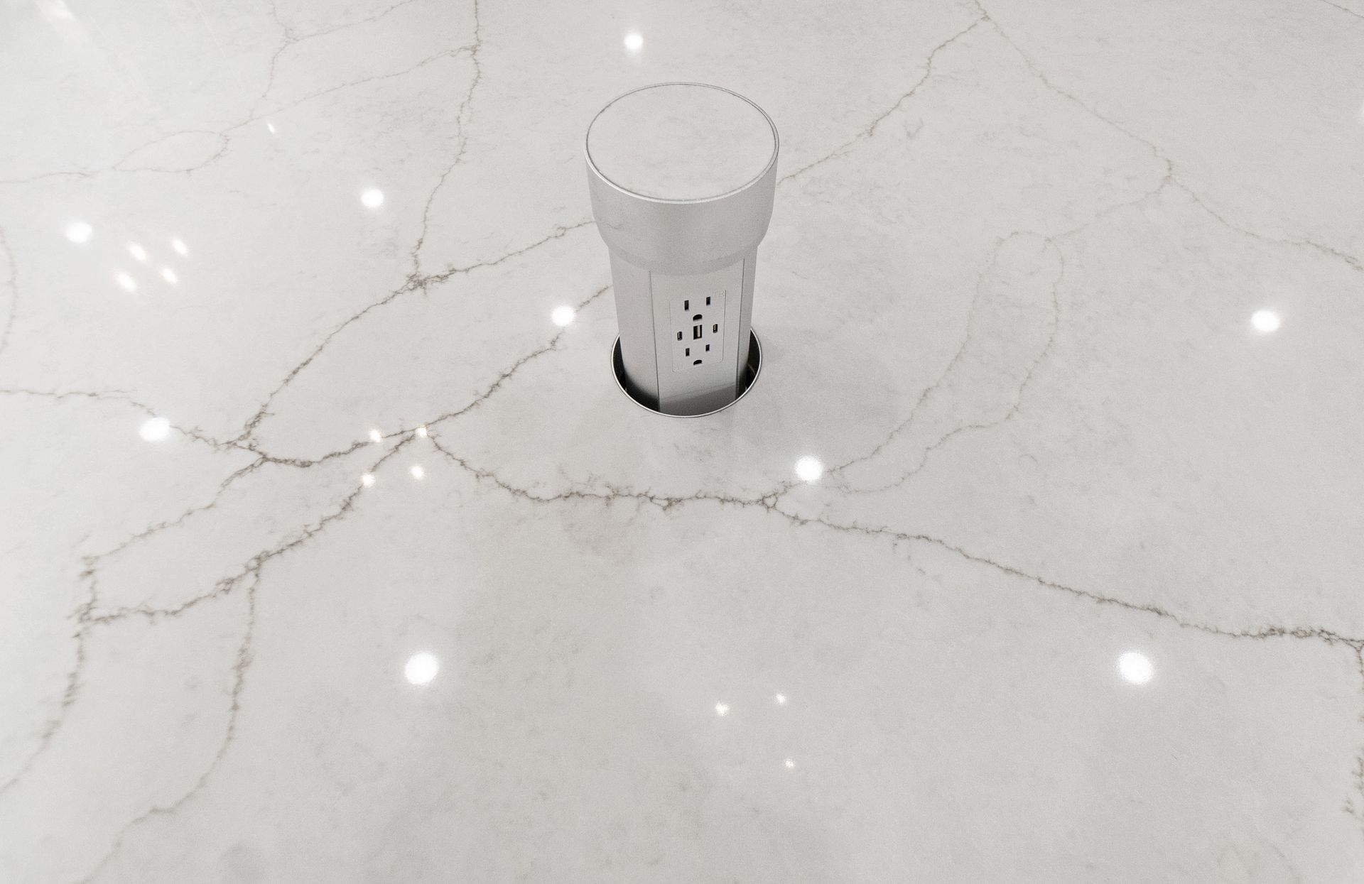 A white bottle is sitting on a white marble floor.