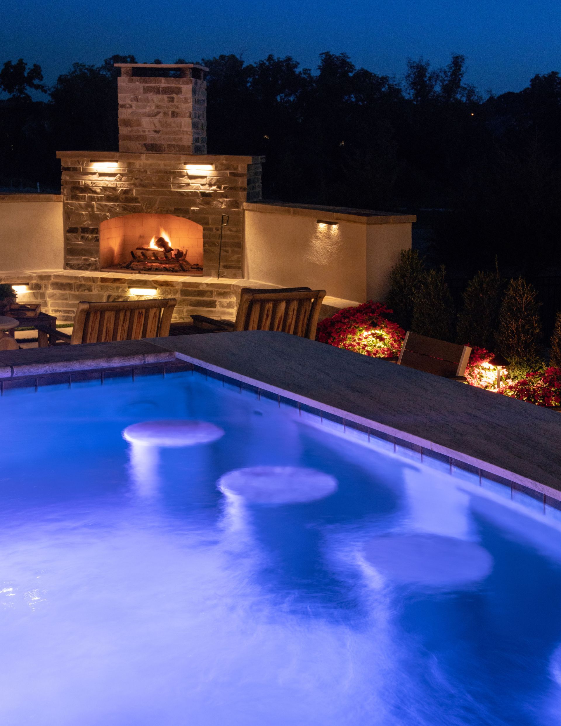 Blue and white tiled pool steps leading to a spa area, styled for a relaxing summer experience. Blue and white tiled pool steps leading to a spa area, styled for a relaxing summer experience.