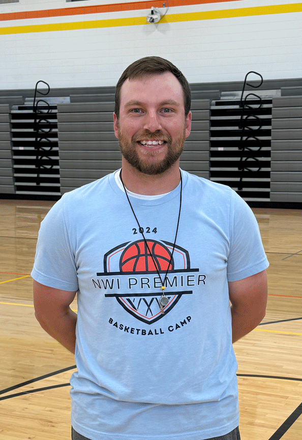 A man wearing a shirt that says nw premier basketball camp