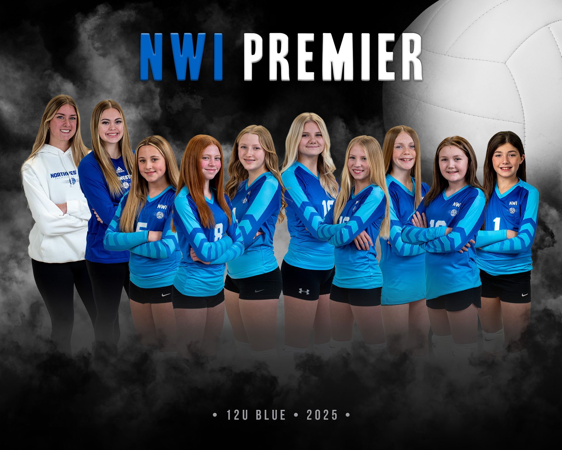A volleyball team is posing for a picture in a gym.