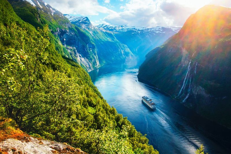 Norwegian fjord with steep mountains and a cruise ship