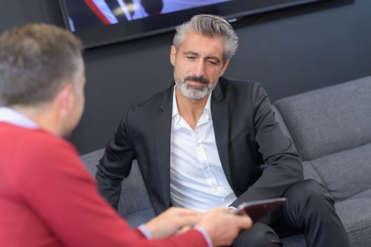 man in red shirt and client in suit