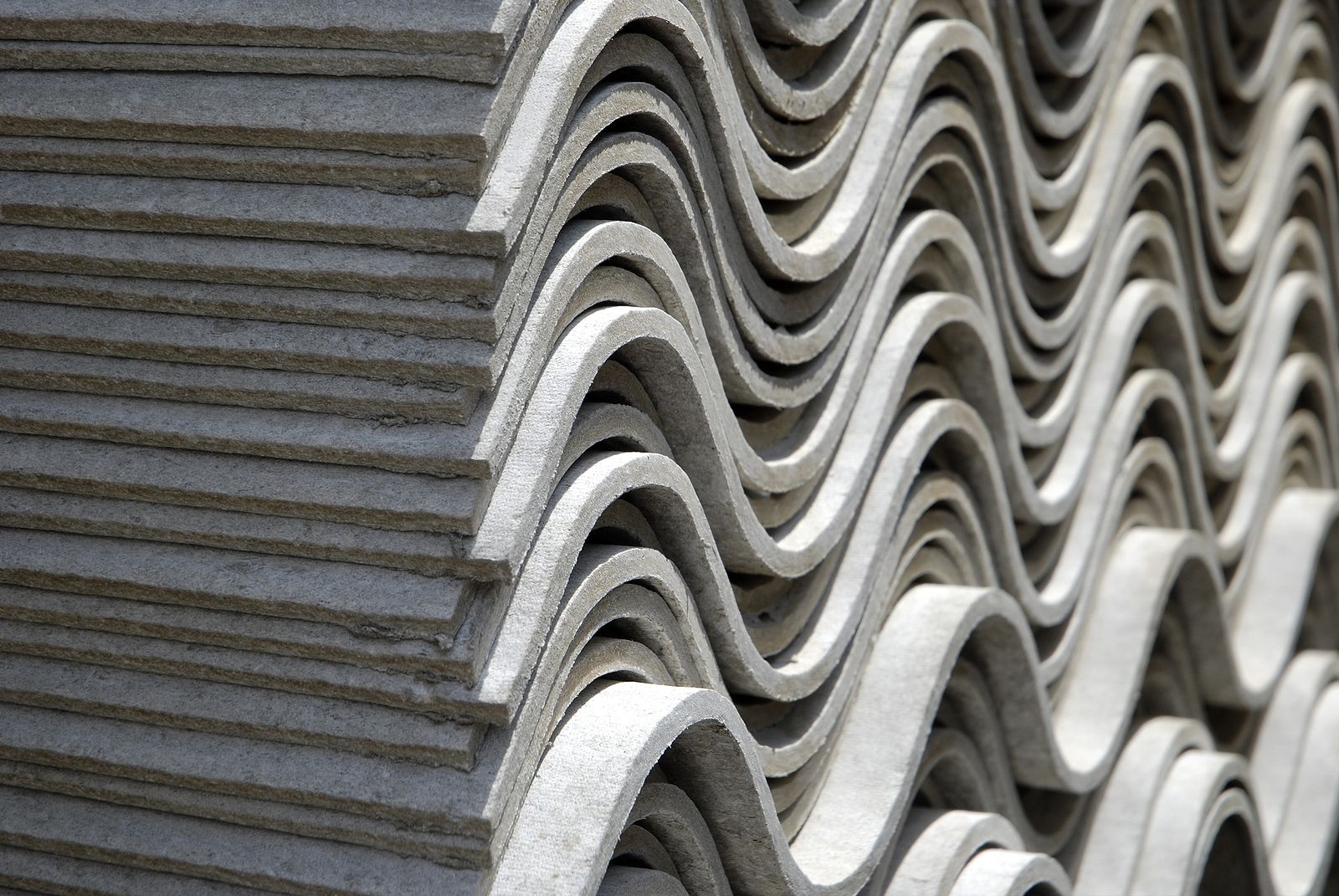 A close up of a stack of corrugated roofing tiles.