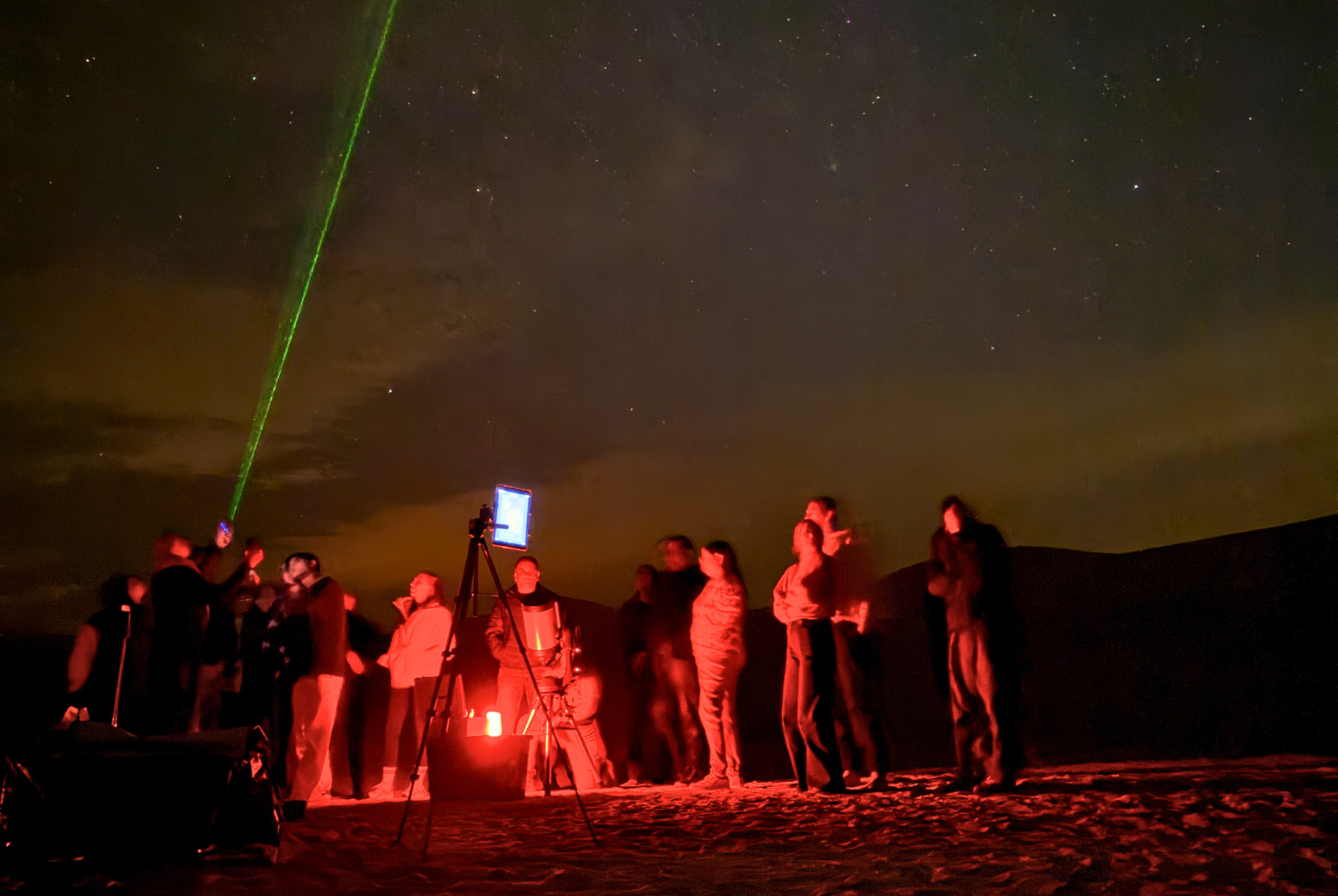 Group gathered outdoors at night in Al Quaa with a professional astronomer and telescope session.