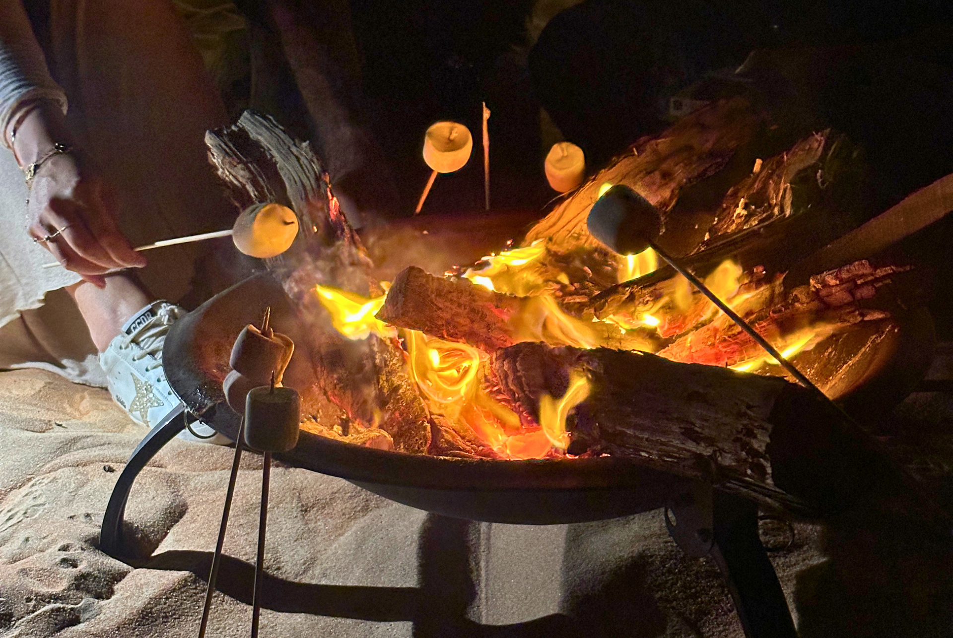 Campfire in a metal fire pit in Al Quaa.