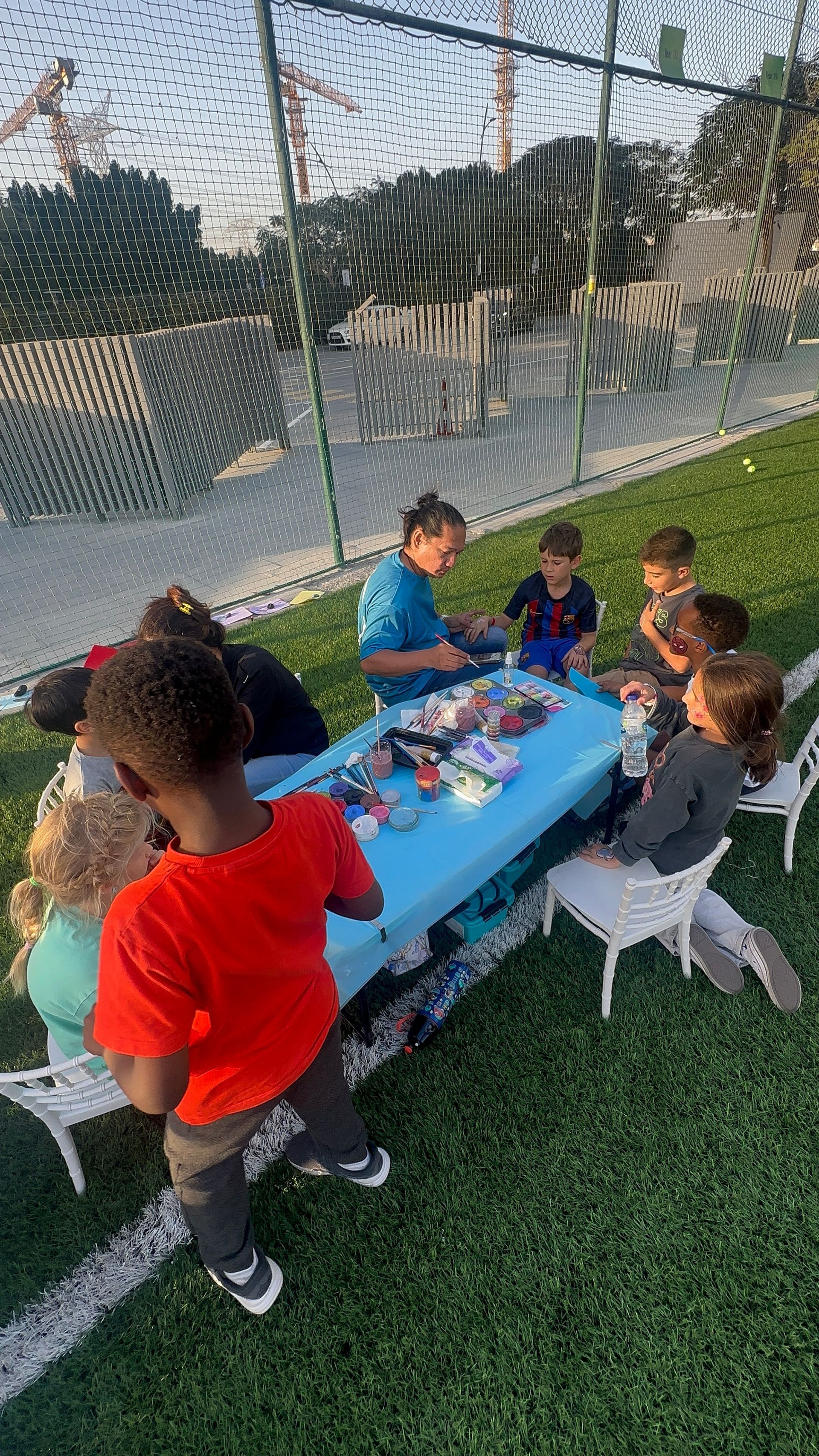 Children gathered around a blue table at Hartland School's in-school camping experience.