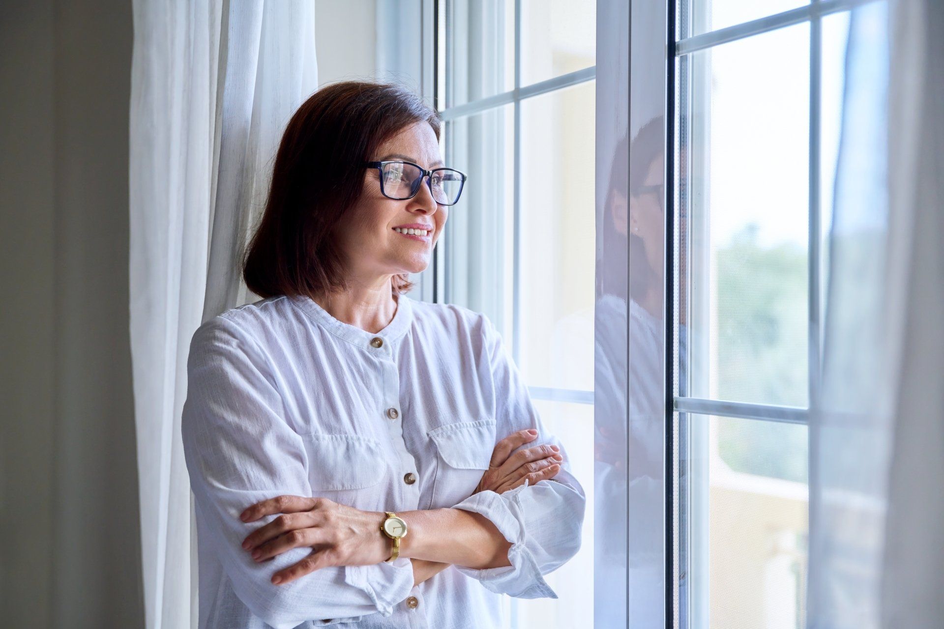 woman looks out a window
