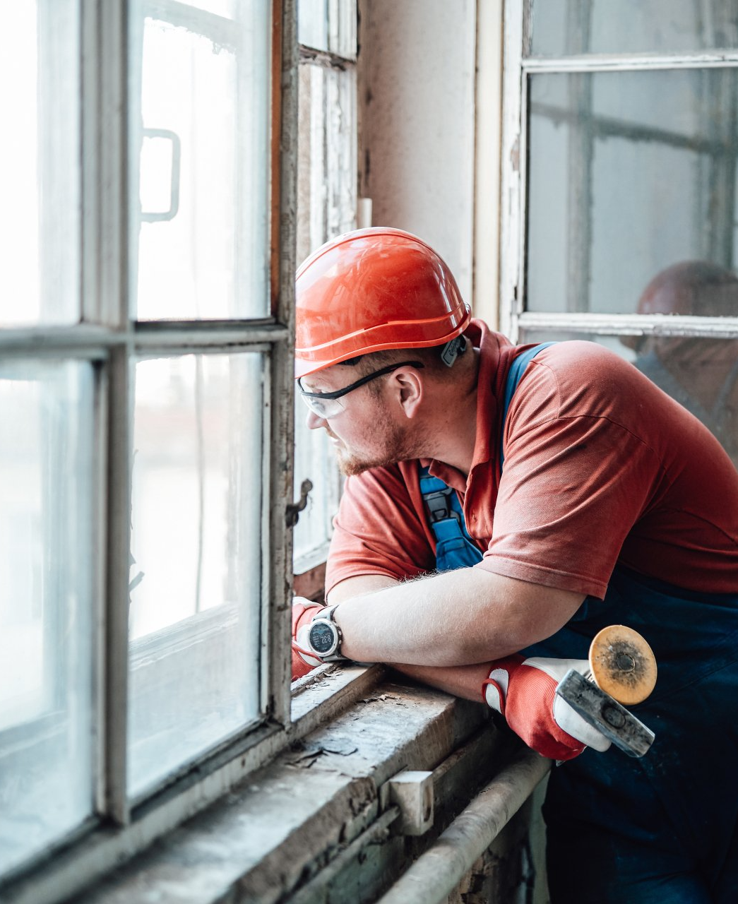 window repairman looking out a window