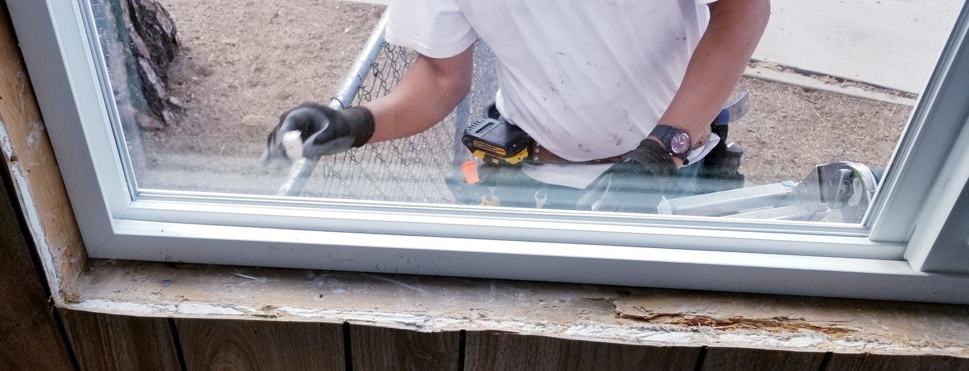 someone on a ladder replacing a window