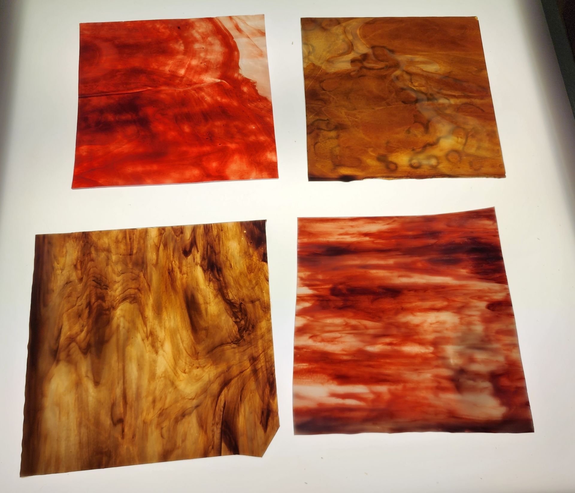 Stained glass sheets in shades of brown, gold  streaky & red streaky Chicago Art Glass in Hartford, WI Stained Glass Studio. 