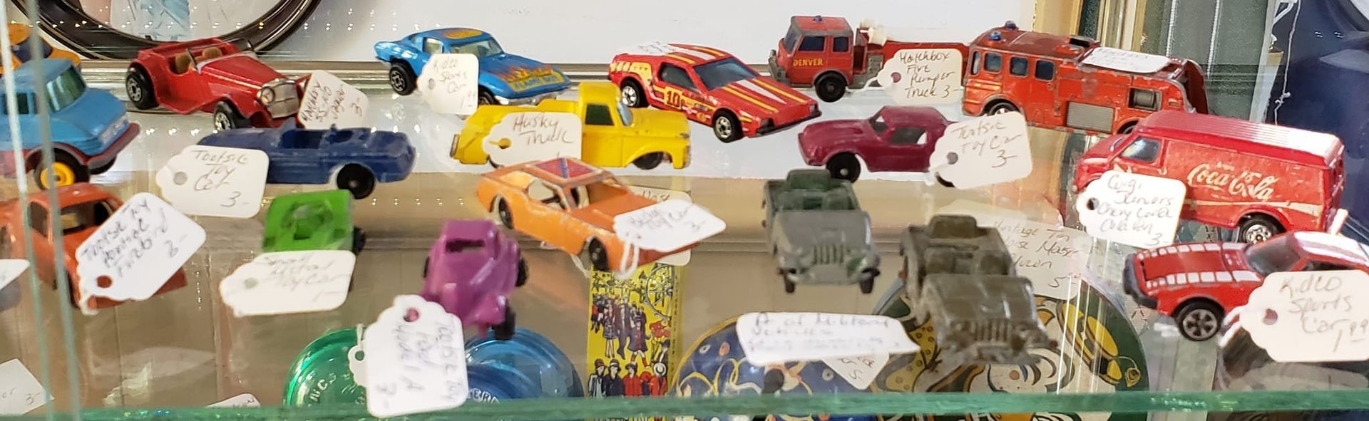 Several vintage brightly colored tiny toy cars for sale at Hen Picked Antiques, Hartford, WI. 