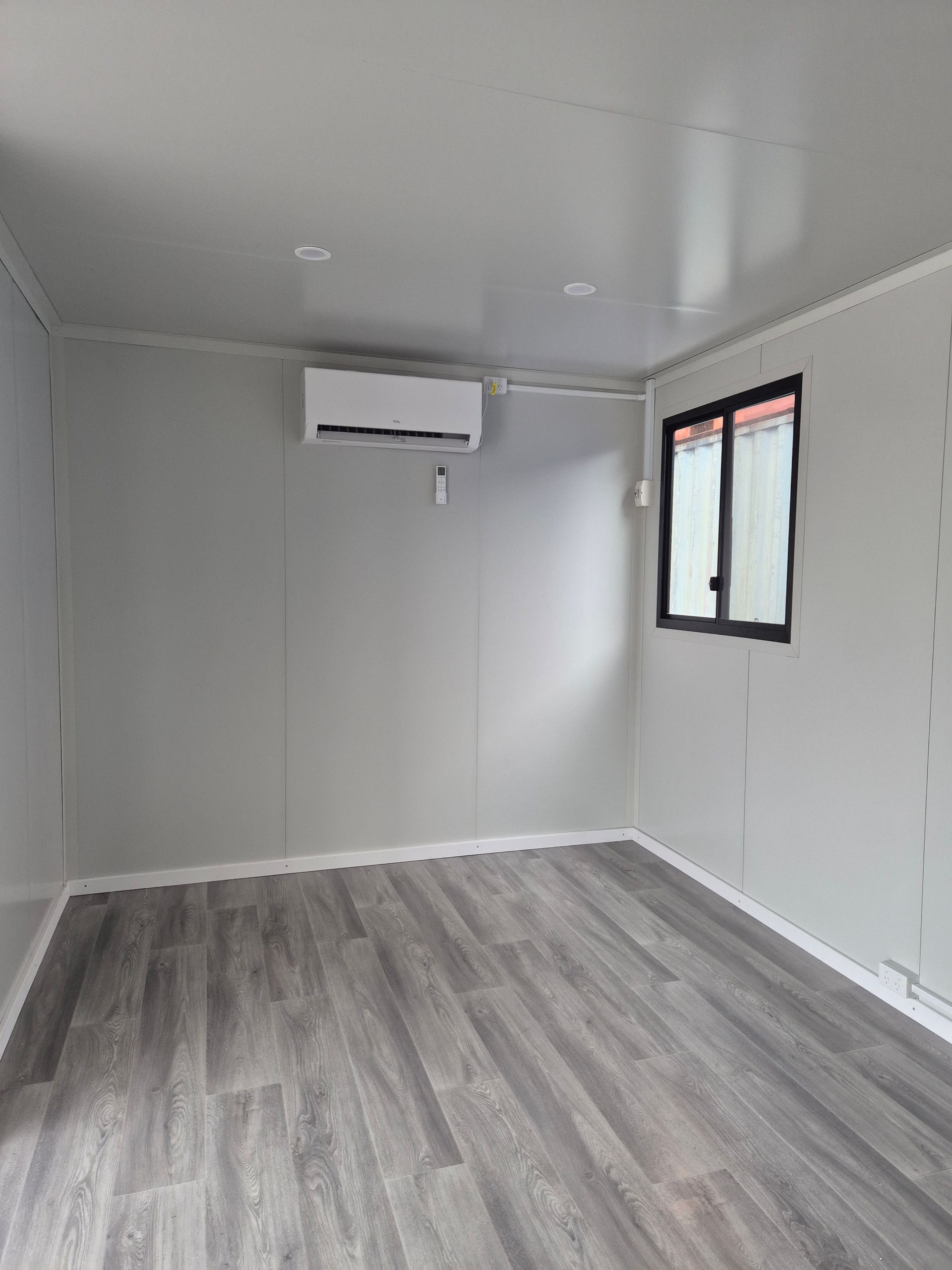 Empty Modern Room With Gray Flooring — Our Display 6x3 Accommodation Unit