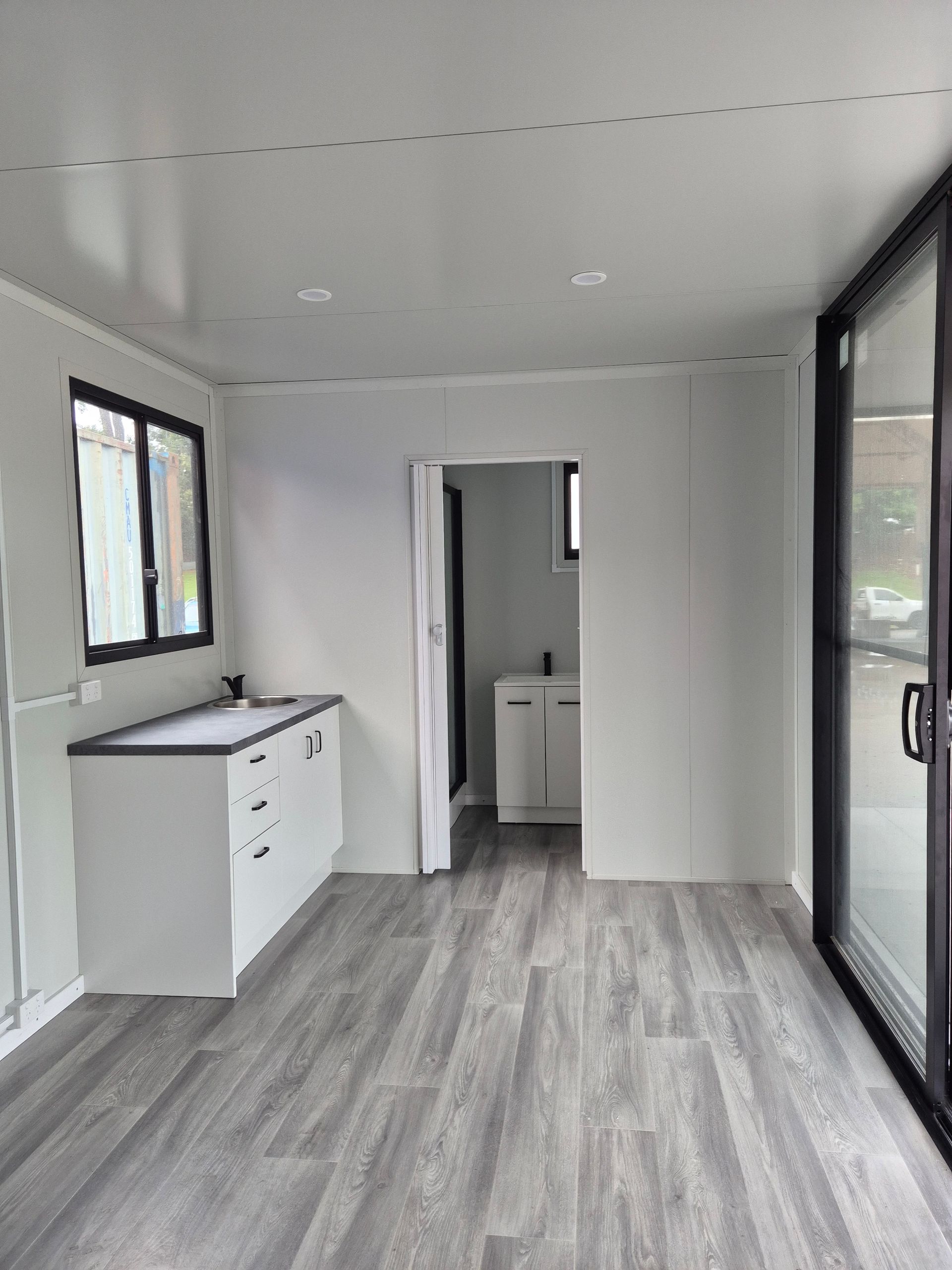 Empty Modern Room With Gray Flooring — Our Display 6x3 Accommodation Unit
