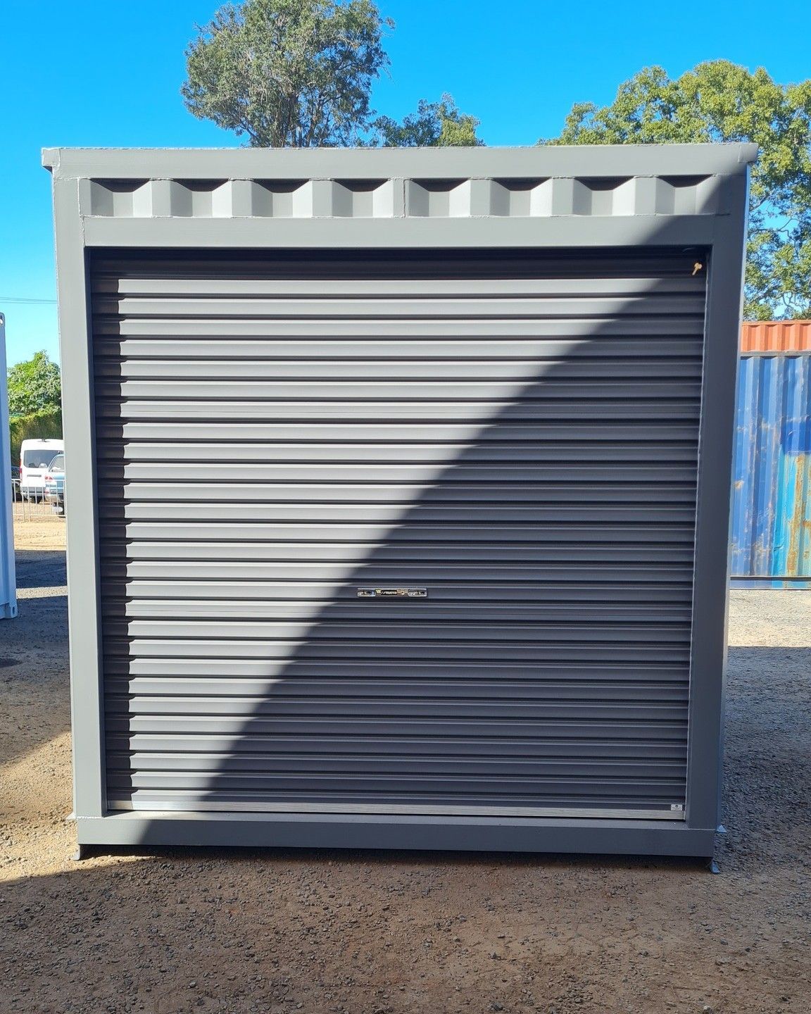 Gray Shipping Container With a Roll-up Door — East Coast Containers Shipping Containers and Transport in Chevallum, QLD