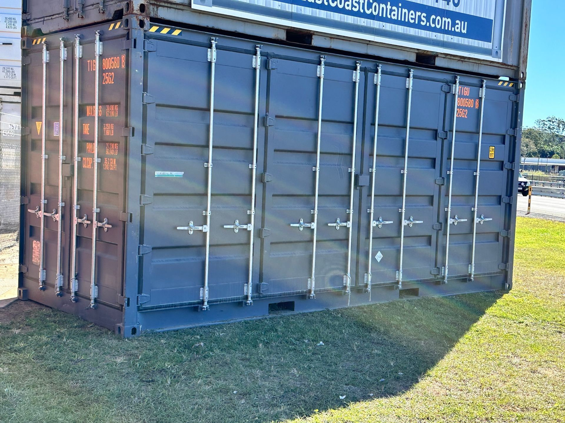 Two Stacked, Dark-coloured Shipping Containers — East Coast Containers Shipping Containers and Transport in Gold Coast, QLD