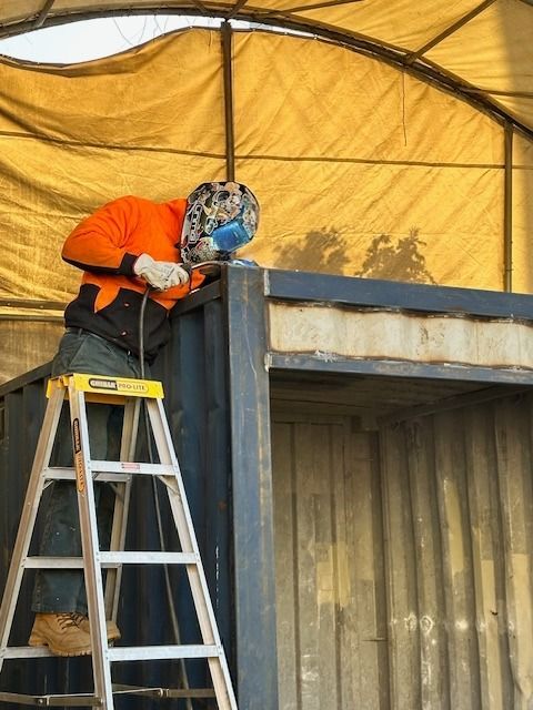 A Person Welds Metal on a Container — East Coast Containers Shipping Containers and Transport in Chevallum, QLD