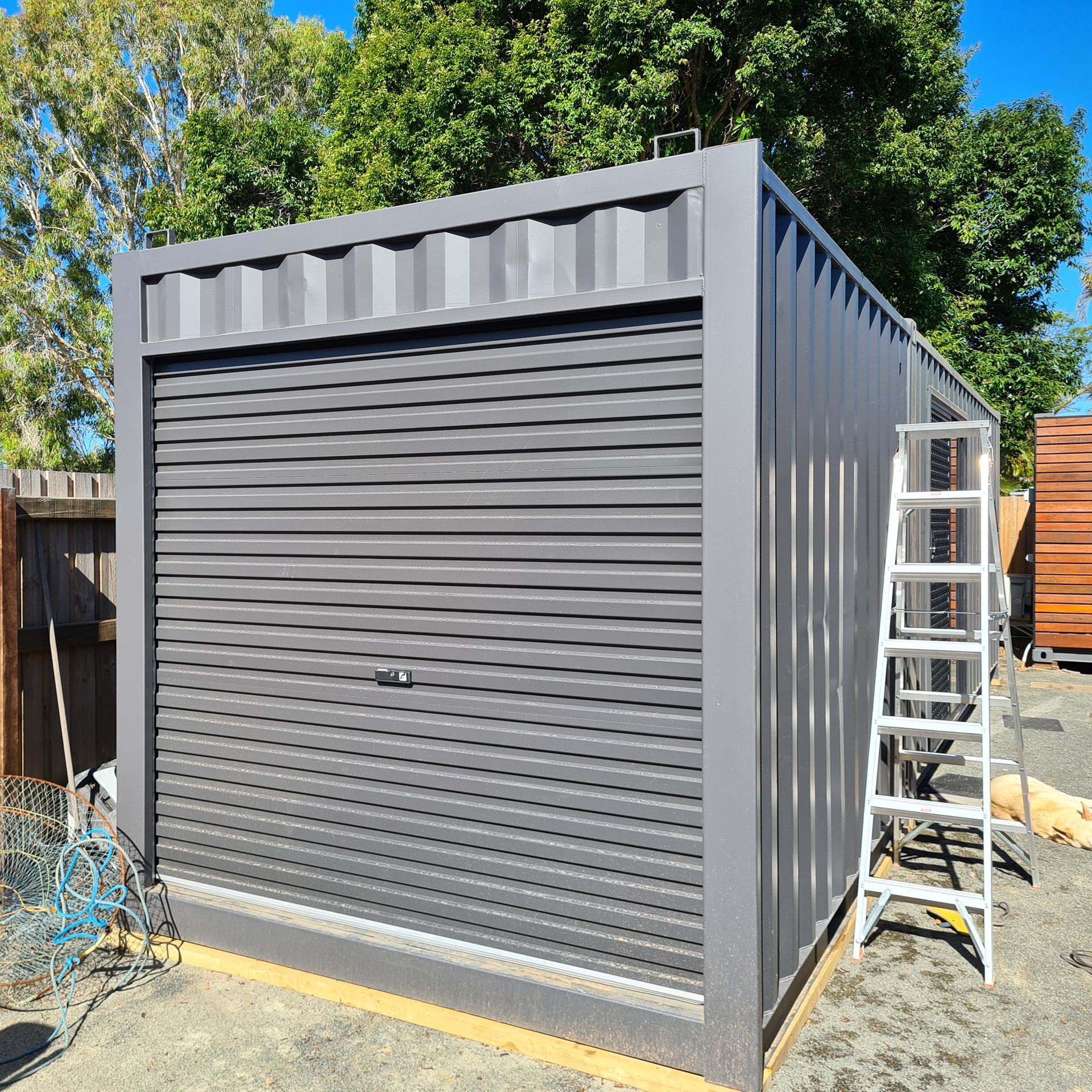 Gray Metal Shed With a Closed Roll — East Coast Containers Shipping Containers and Transport in Chevallum, QLD